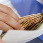 Person handling financial documents for property management or letting agency.