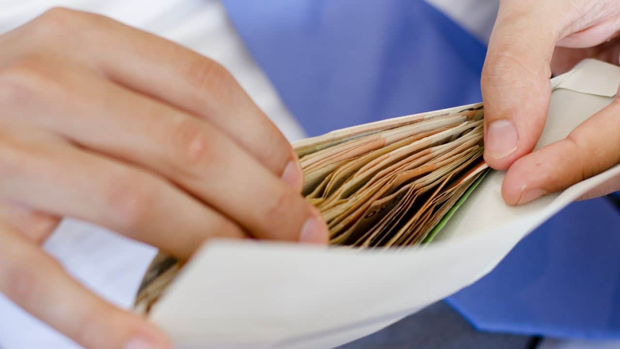 Person handling financial documents for property management or letting agency.