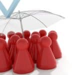 Red game pieces under a transparent umbrella symbolising protection in property management.