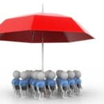 Miniature figures under a red umbrella symbolising protection or teamwork.